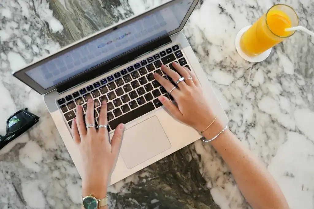 Woman working on a laptop on a countertop | Moxie360 Marketing
